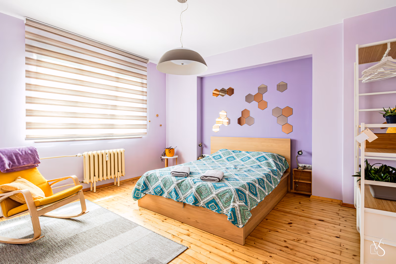 Primary bedroom — queen bed, clean lines, warm light